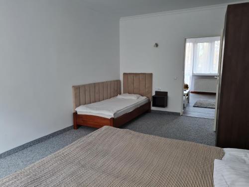 a bedroom with two beds and a window at Apartament Centrum 3 Maja in Mikołajki