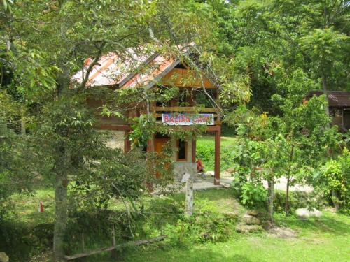 a small house with a sign on the side of it at Balian Camp penginapan in Tuk Tuk