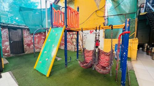 a play room with a slide and swings at FARM HOUSE RESIDENCY in Vasai