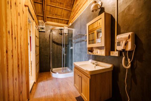 a bathroom with a sink and a shower at Tayama Farm Khaoyai in Nakhon Ratchasima