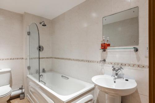 a bathroom with a sink and a tub and a toilet at Liverpool City Centre Apartments - East Village in Liverpool