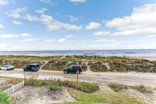 two cars parked in a parking lot near the beach at Ocean Ave Seaside Cottage in Fernandina Beach