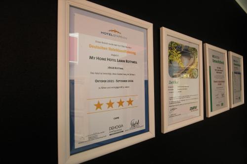 three framed certificates are hanging on a wall at MY HOME Hotel Lamm Rottweil "Smart Home" in Rottweil