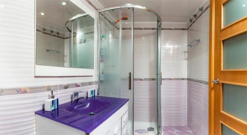 y baño con lavabo púrpura y ducha. en Parrot`s House Fenals, en Lloret de Mar