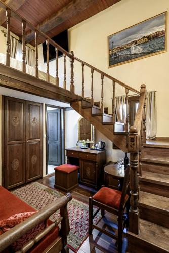 a living room with a spiral staircase and a kitchen at Porto Del Colombo Traditional Boutique Hotel in Chania Town