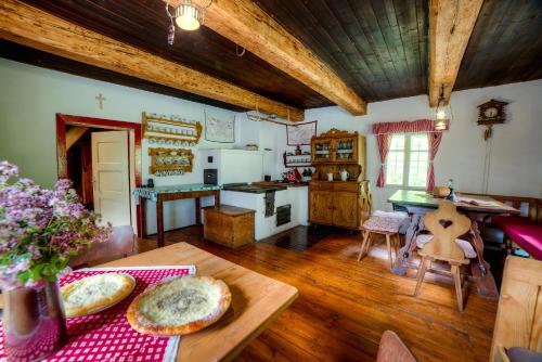 a kitchen with a table with two pizzas on it at Chaloupka Prischlop in Velké Karlovice