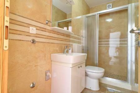 a bathroom with a toilet and a sink at Apartments Seafront Silence in Trstenik