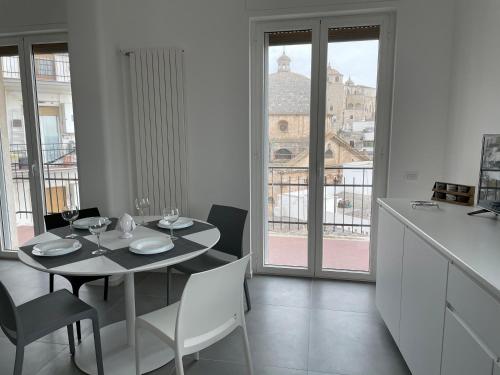 a dining room with a table and a view of the city at La casa di Zoe in Ceglie Messapica