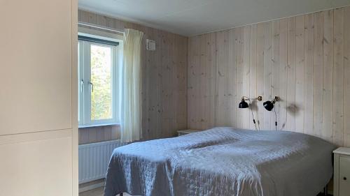 Кровать или кровати в номере Ljugarnsstugor