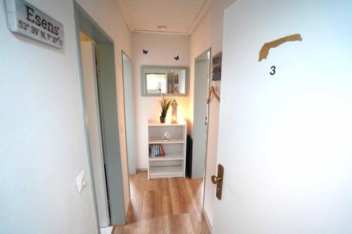 a hallway with a door open to a room at Ferienwohnung Langeoog in Neuharlingersiel