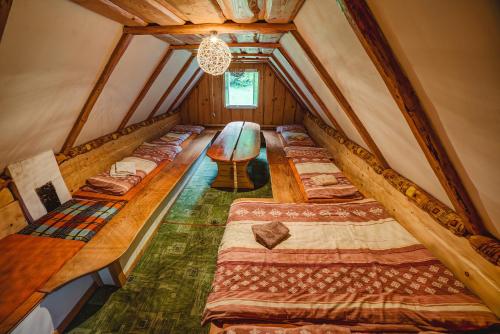 a room with a bunch of beds in a attic at Chaloupka Prischlop in Velké Karlovice