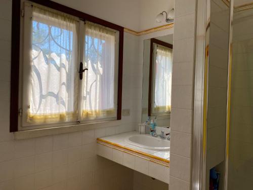 a bathroom with a sink and a window at La Casa di Paola in Castel di Mezzo