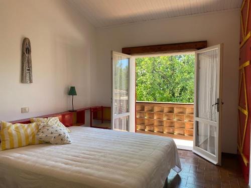 a bedroom with a bed and a large window at La Casa di Paola in Castel di Mezzo