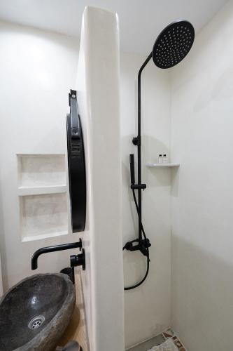 a bathroom with a sink and a shower at Camo’s house in Poros