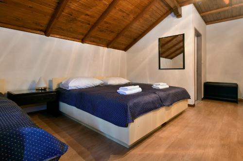 a bedroom with a bed with two towels on it at Gostilna Lokve in Lokve