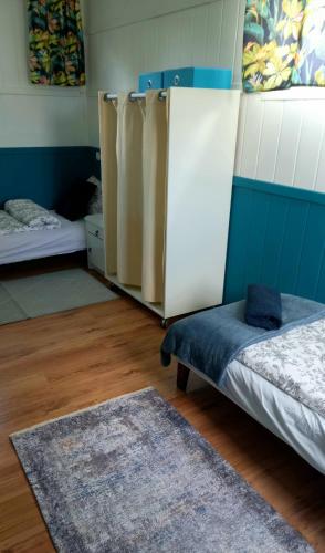 a room with two beds and a rug at Domek Wilamów in Wilamów