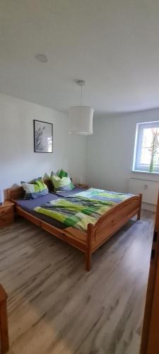a bedroom with a large bed in a room at Am Walde in Trassenheide