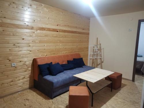 a couch in a room with a wooden wall at Tevra Hotel, Top of the Mountain, Camping, Nature, Ijevan, Dilijan in Ijevan