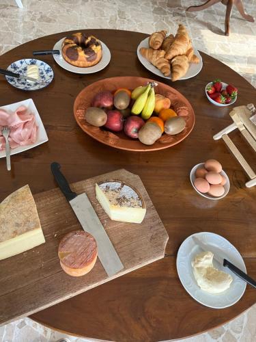 a wooden table topped with lots of different types of food at Belvedere Bike Hotel in Montà