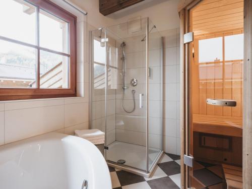 a bathroom with a white tub and a shower at VAYA Kaprun inklusive Zell am See Kaprun Sommer Karte in Kaprun