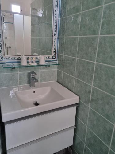 a bathroom with a sink and a mirror at STELLA MARE in Algajola