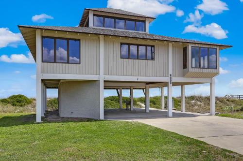 a house on the side of a beach at Oceanfront Pet Friendly Unit in Fernandina Beach