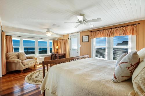 a bedroom with a bed and a large window at Rustic Oceanfront Cottage in Fernandina Beach
