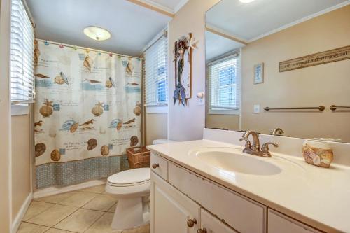 a bathroom with a sink and a toilet and a shower at Rustic Oceanfront Cottage in Fernandina Beach