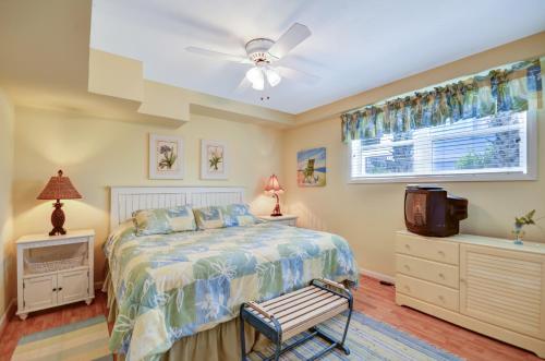 a bedroom with a bed and a ceiling fan at DogFriendly Duplex in Fernandina Beach
