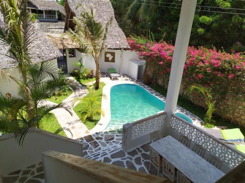 a view of the pool from the balcony of a villa at Garoda House Turtle Bay [ Jacuzzi ☆☆☆☆☆ ] Kilifi in Watamu