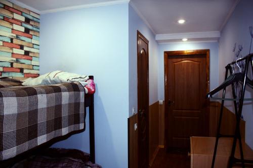 a room with a bed and a hallway with a door at motel Pid Strihoyu in Kremenchuk