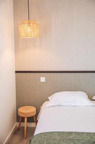 a bedroom with a bed and a chair and a lamp at Casa dos Capuchos in Leiria