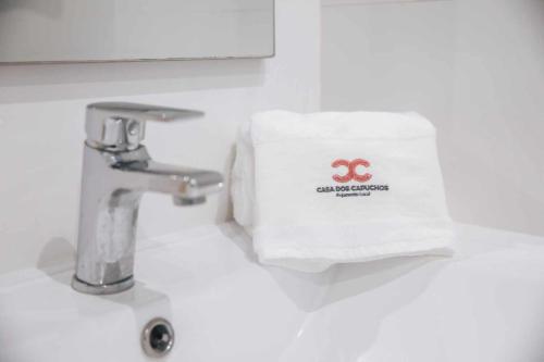 a towel sitting on a sink next to a faucet at Casa dos Capuchos in Leiria