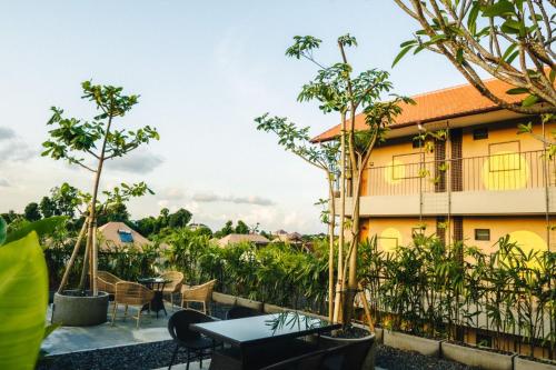 a view from the balcony of a hotel with trees at Tanaga CoLiving in Seminyak