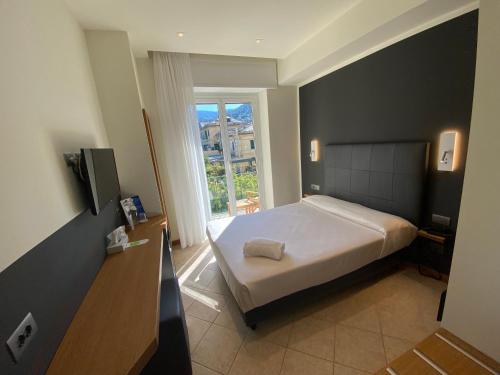 a bedroom with a large bed and a window at Hotel Garden in Levanto