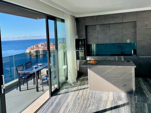 a kitchen with a view of the ocean at Apartments Fortes Fortuna in Dubrovnik