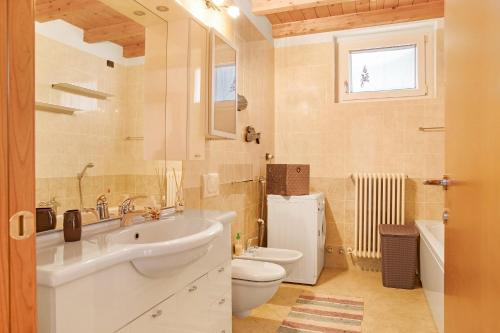 a bathroom with a sink and a toilet at Casa Vacanze Il Mandala in Sondrio