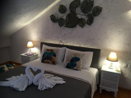 a bedroom with a bed with two swans on it at Virvilis Apartments in Sivota