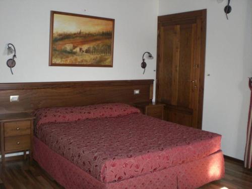 a bedroom with a bed and a dresser at Fonte Dei Tufi in Siena