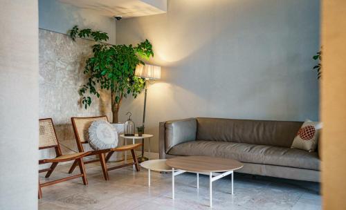 a living room with a couch and chairs and a table at Geoje Mongdol Beach H Avenue Hotel in Geoje 