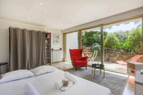 une chambre avec un lit et une chaise rouge dans l'établissement Studio A/C La Californie with patio by Olidesi, à Cannes