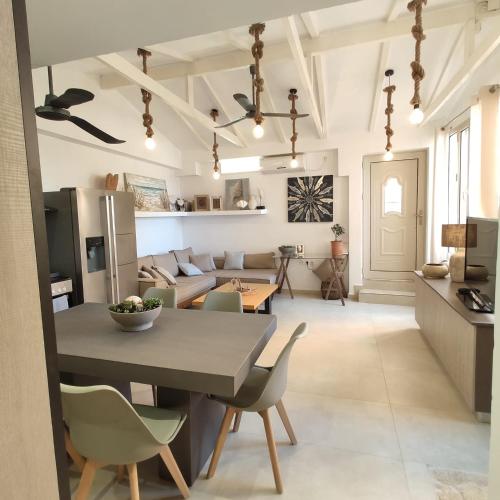 a kitchen and living room with a table and chairs at Waterside Apartments in Ayia Evfimia