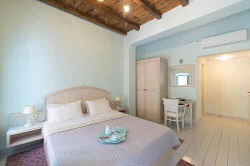 a bedroom with a bed with a tray on it at 999 Luxury Hotel in Nafplio