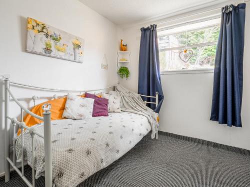 a bedroom with a bed and a window at Holiday Home Lochness by Interhome in Contin