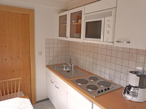 a kitchen with a sink and a counter top at Apartment Schimpfössl Katharina-1 by Interhome in Sankt Anton am Arlberg