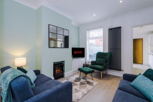 a living room with a couch and a fireplace at Phillip House in Chester