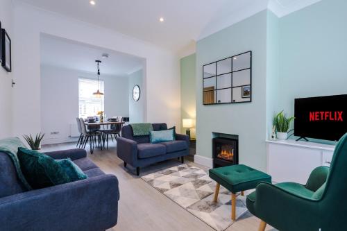 a living room with two couches and a fireplace at Phillip House in Chester