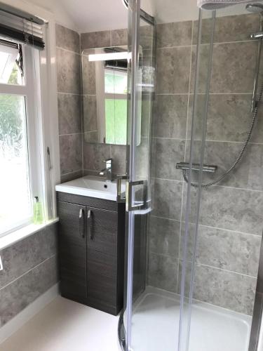 a bathroom with a shower and a sink at Cornerways in Ventnor