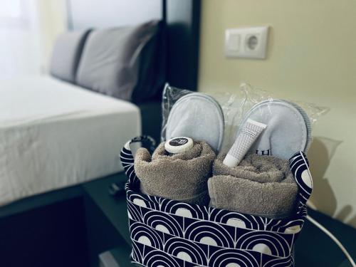 a bag with a pair of shoes and a towel at PALM LIFE APARTMENT- Free Parking in Villareal