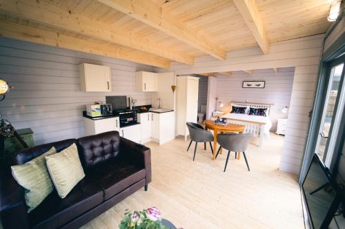 a living room with a couch and a table with chairs at The Snug, Cromer, a short walk to the beach. in Cromer
